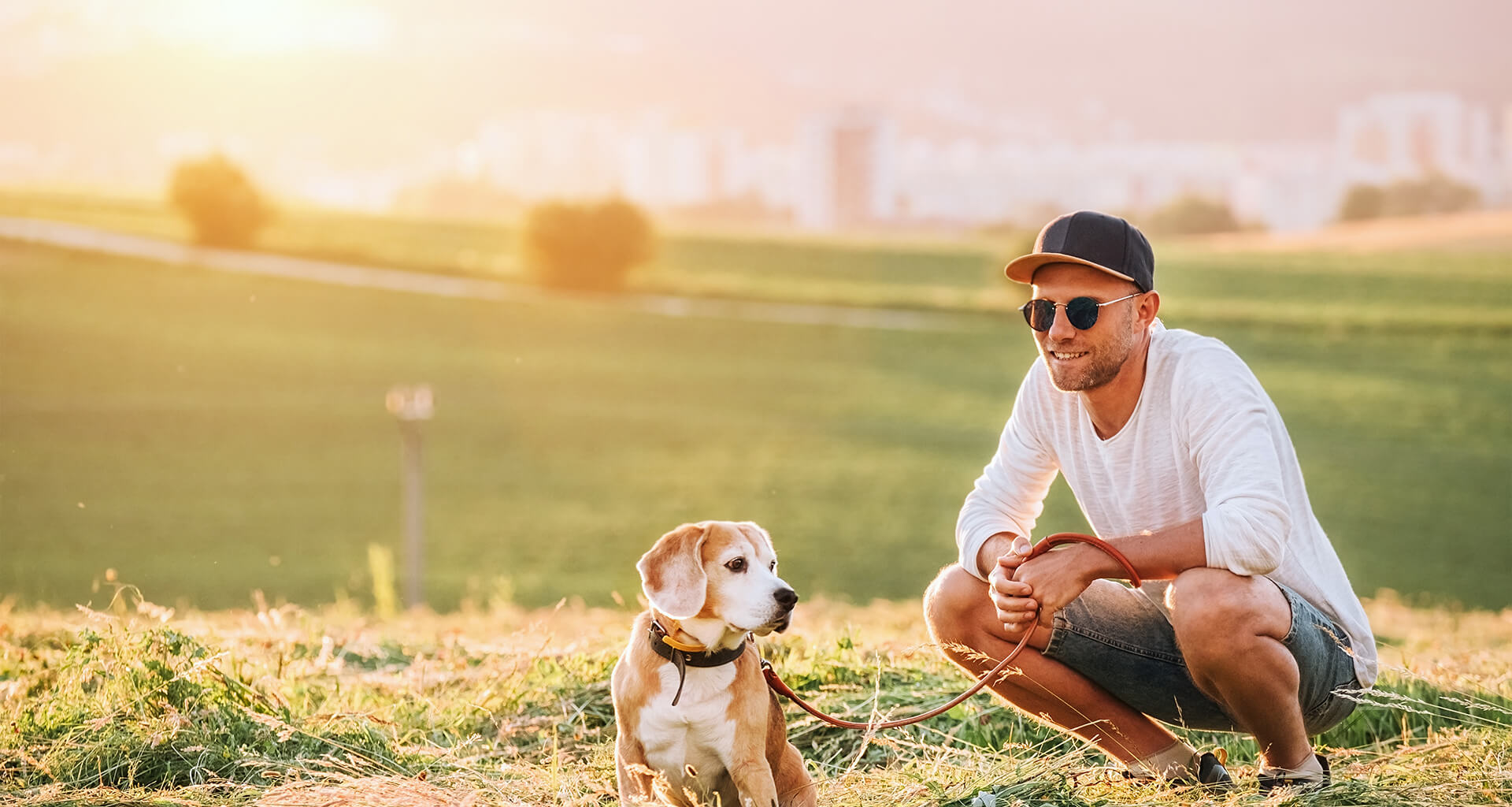 Man Smiling While Playing With Dog